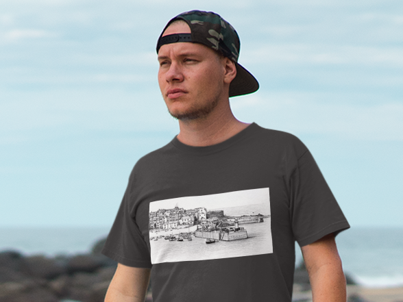 Man wearing Asphalt grey St Ives harbour illustration t-shirt, Bella+Canvas unisex tee on the beach