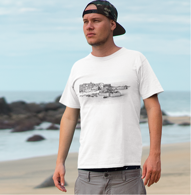 Man wearing St Ives harbour graphic tee on beach, white coastal t-shirt