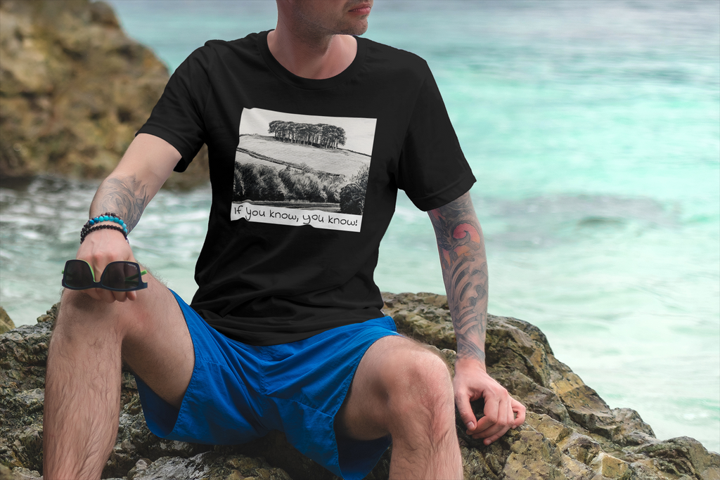 Model wearing Black Nearly There Trees Cornwall t-shirt on the beach, holiday tee