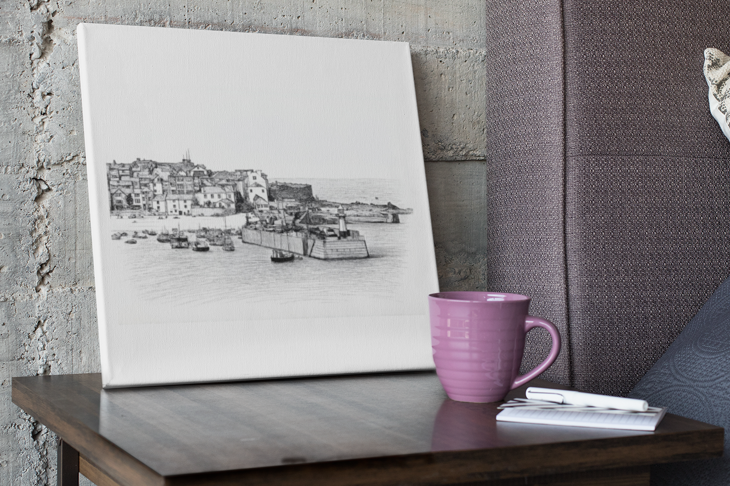 St Ives Harbour Cornwall canvas print on desk beside coffee cup, coastal wall art inspired by Cornwall's historic harbour