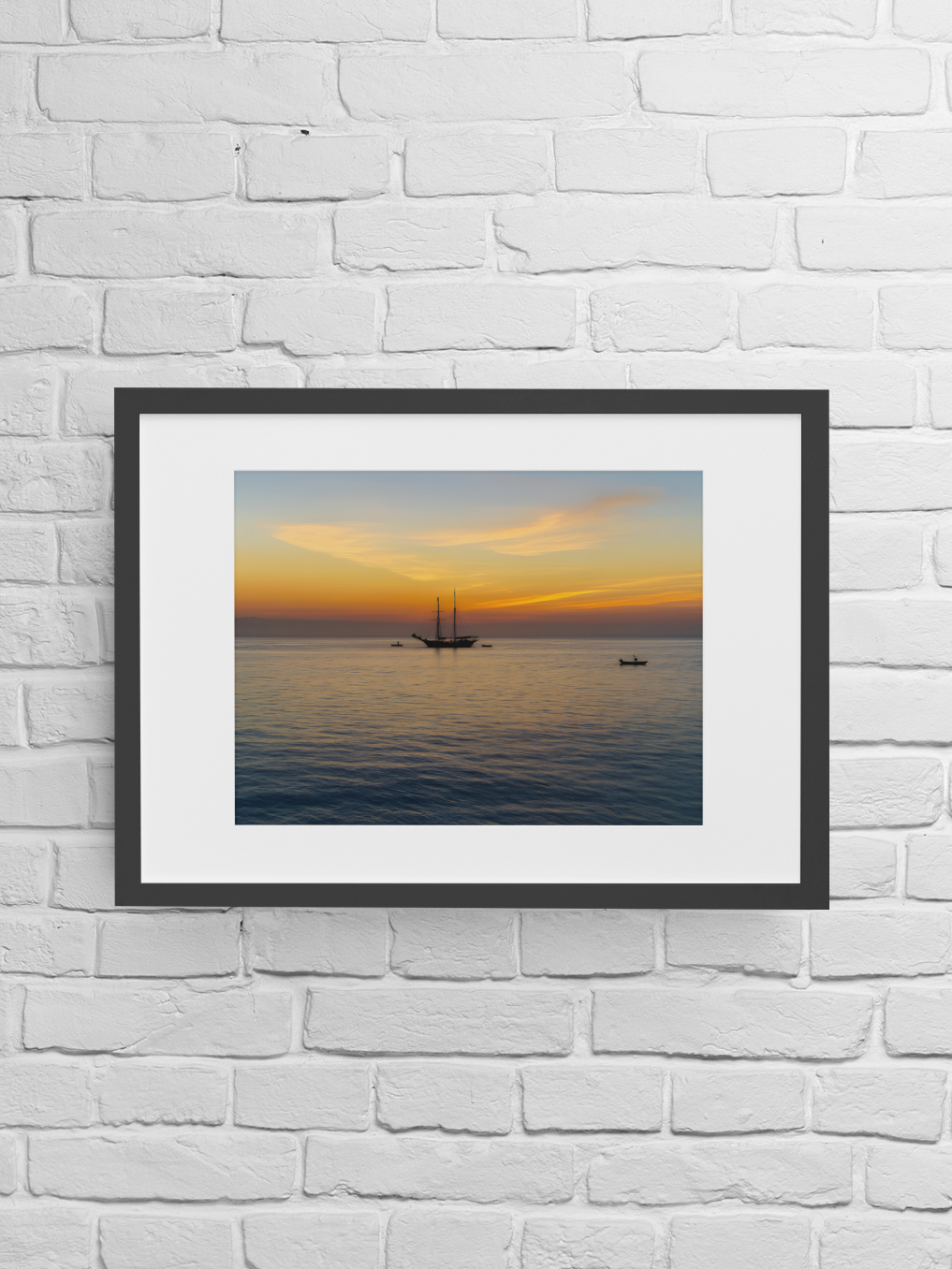 Sunrise Over St Ives Bay Cornwall fine art print in frame on white brick wall – golden seascape giclée art