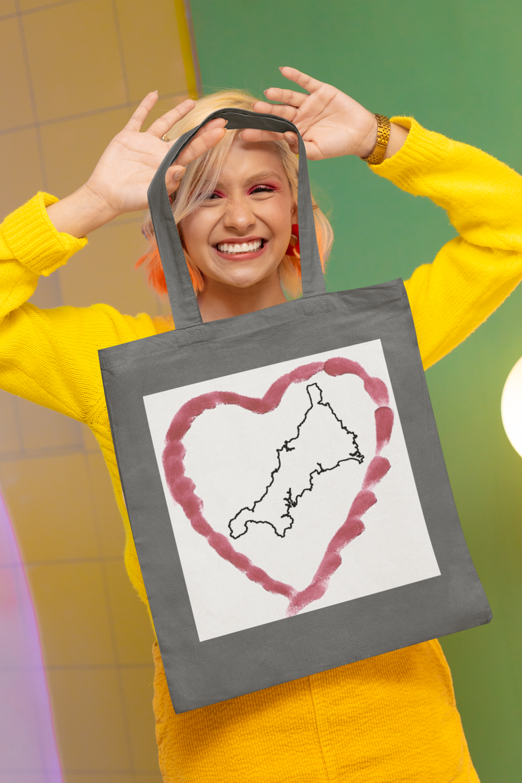 Woman holding Grey I Love Cornwall tote bag — Kernow heart map cotton gift shopper