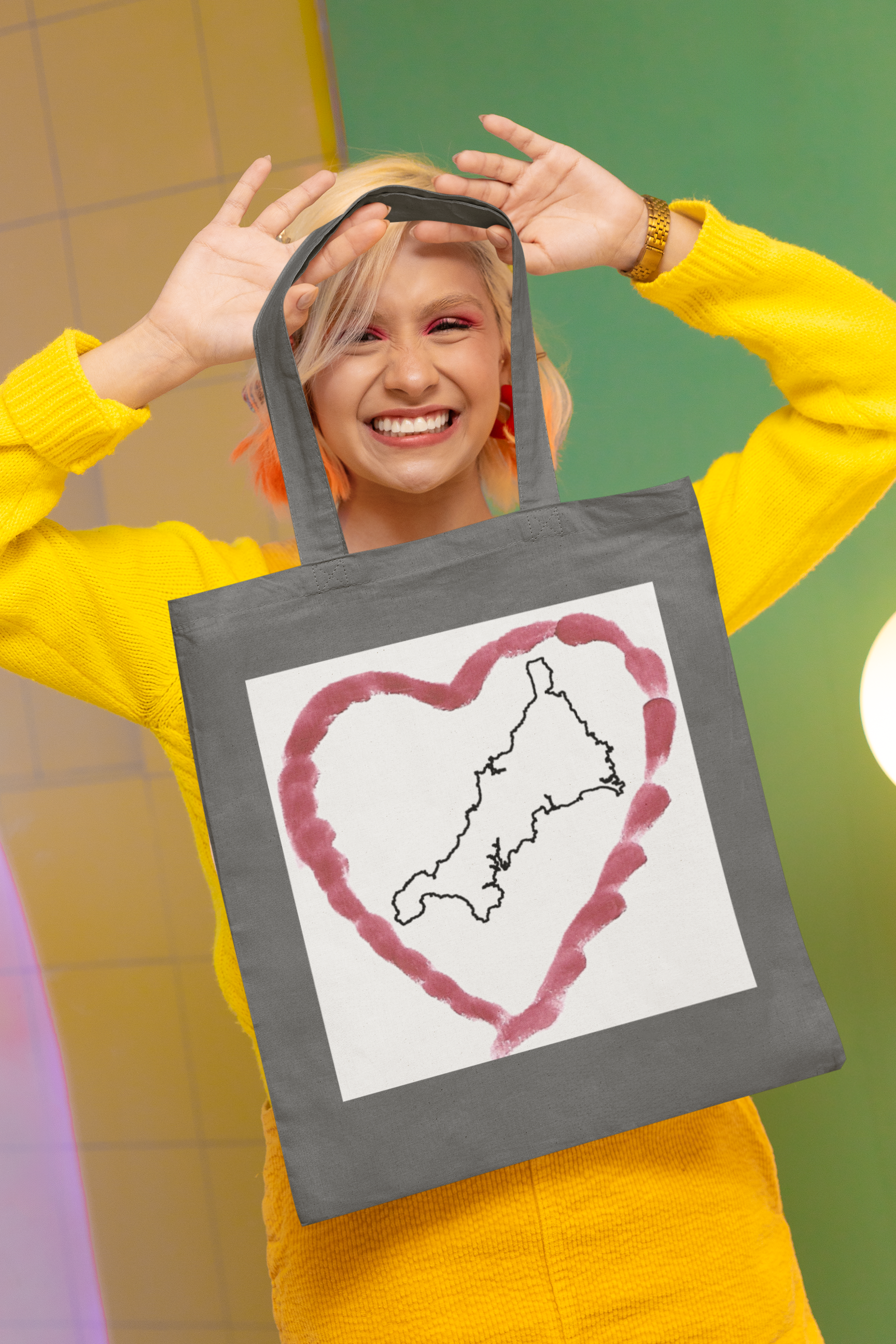 Woman holding Grey I Love Cornwall tote bag — Kernow heart map cotton gift shopper