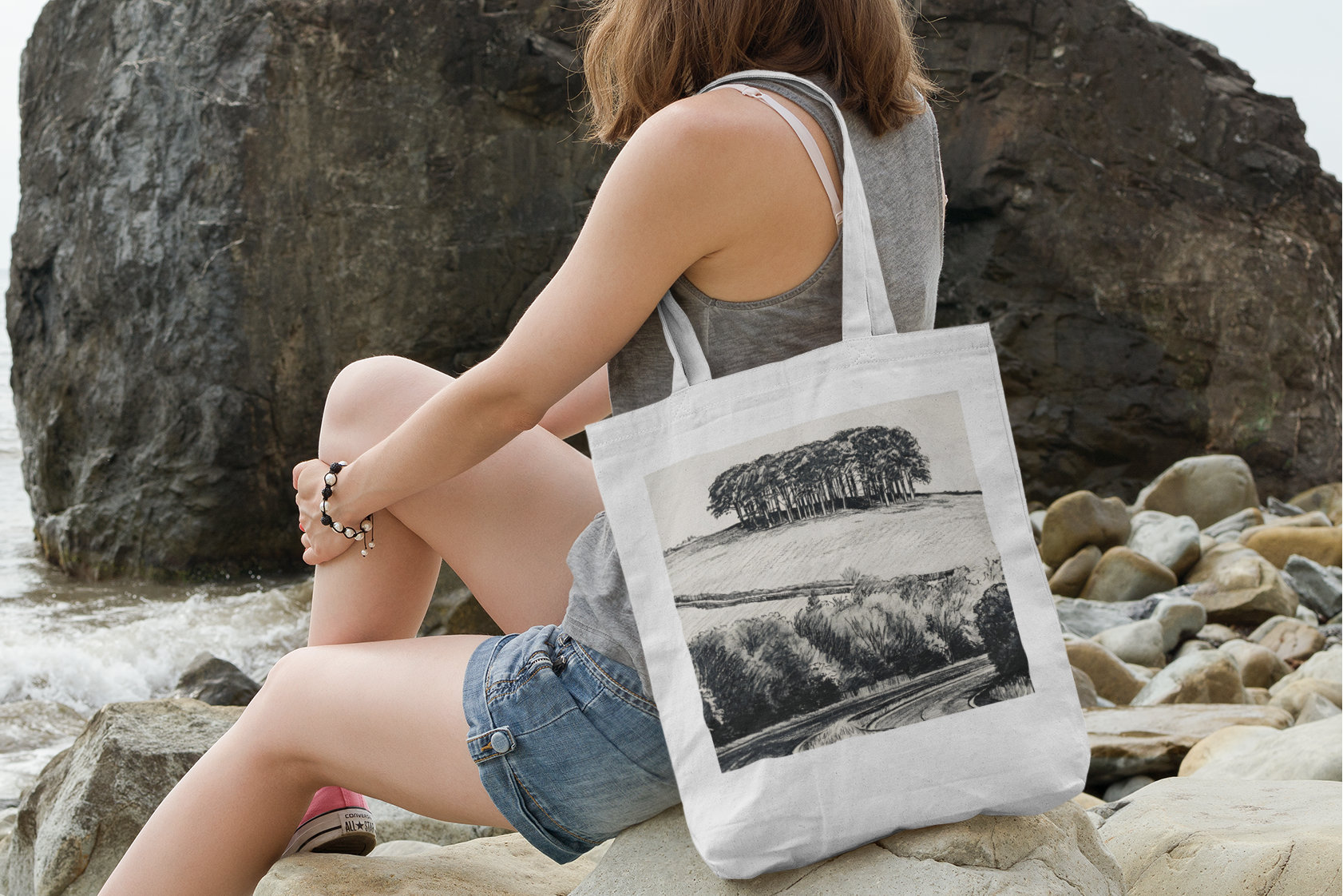 Woman holding White Cornwall A30 nearly there trees tote bag with sea view, Cookworthy Knapp design