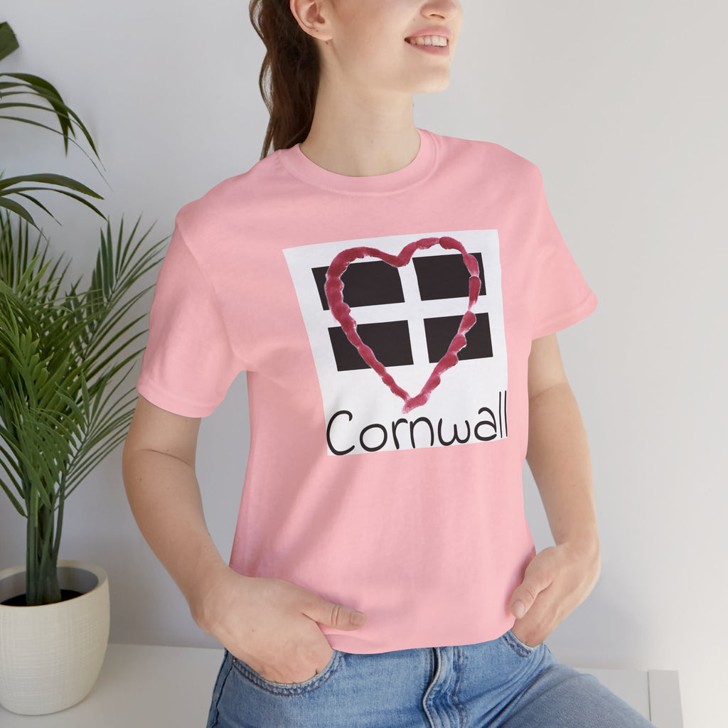 Woman in holiday home wearing pink Cornwall Heart Flag graphic t-shirt 