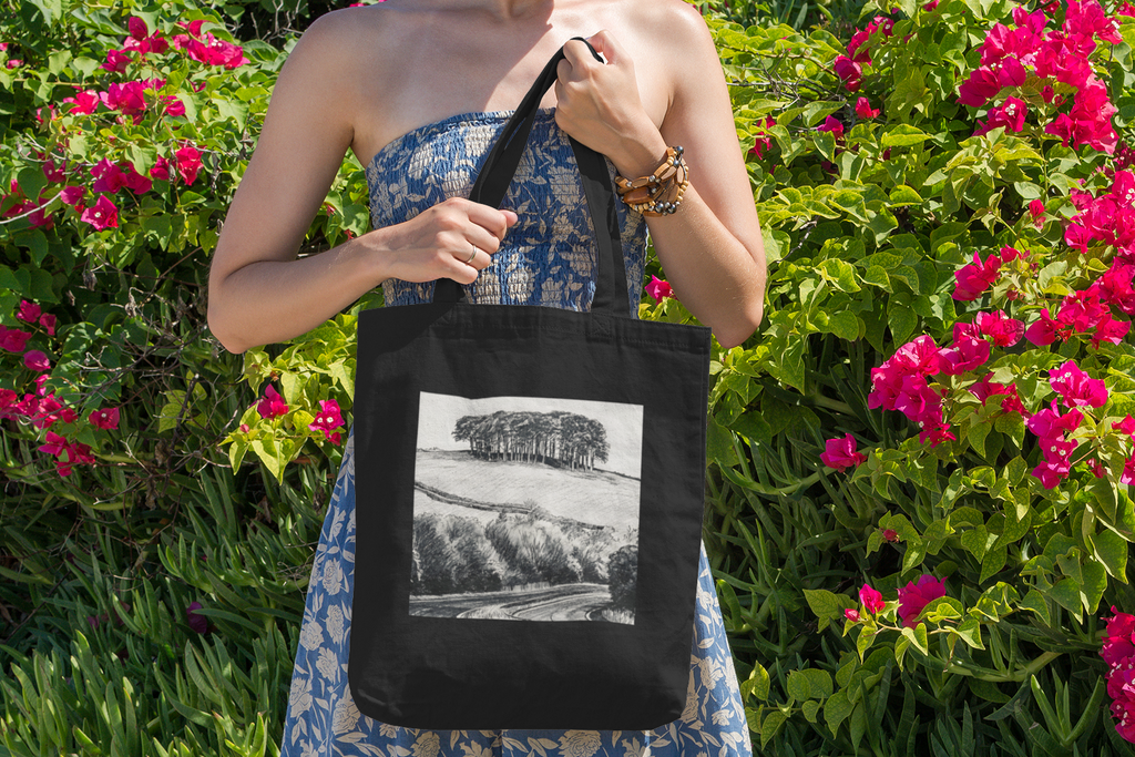 Woman with black Nearly There Trees Cornwall tote bag near flowers, holiday gift bag