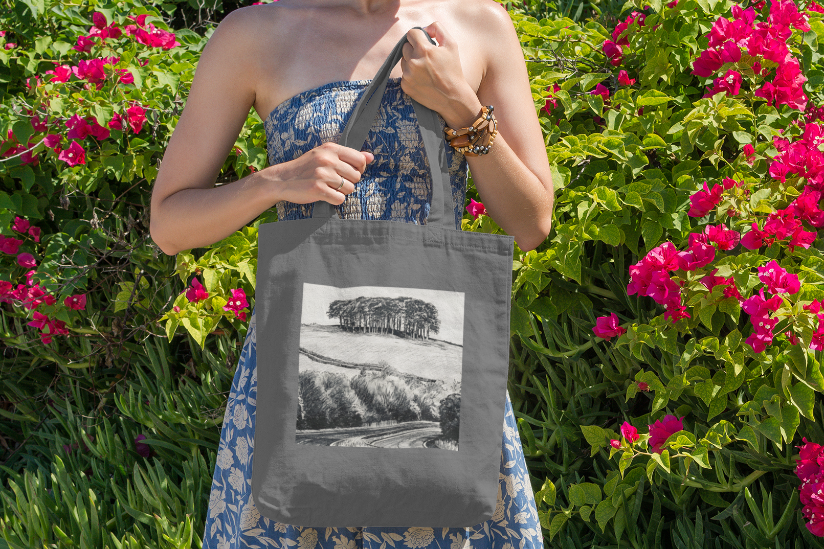 Woman with grey Nearly There Trees Cornwall tote bag near flowers, holiday gift bag