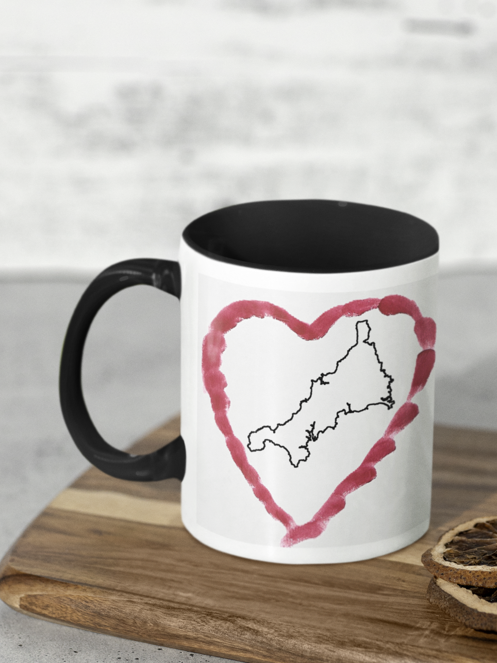 I Love Cornwall heart map mug with black handle on wooden board, Cornwall outline design