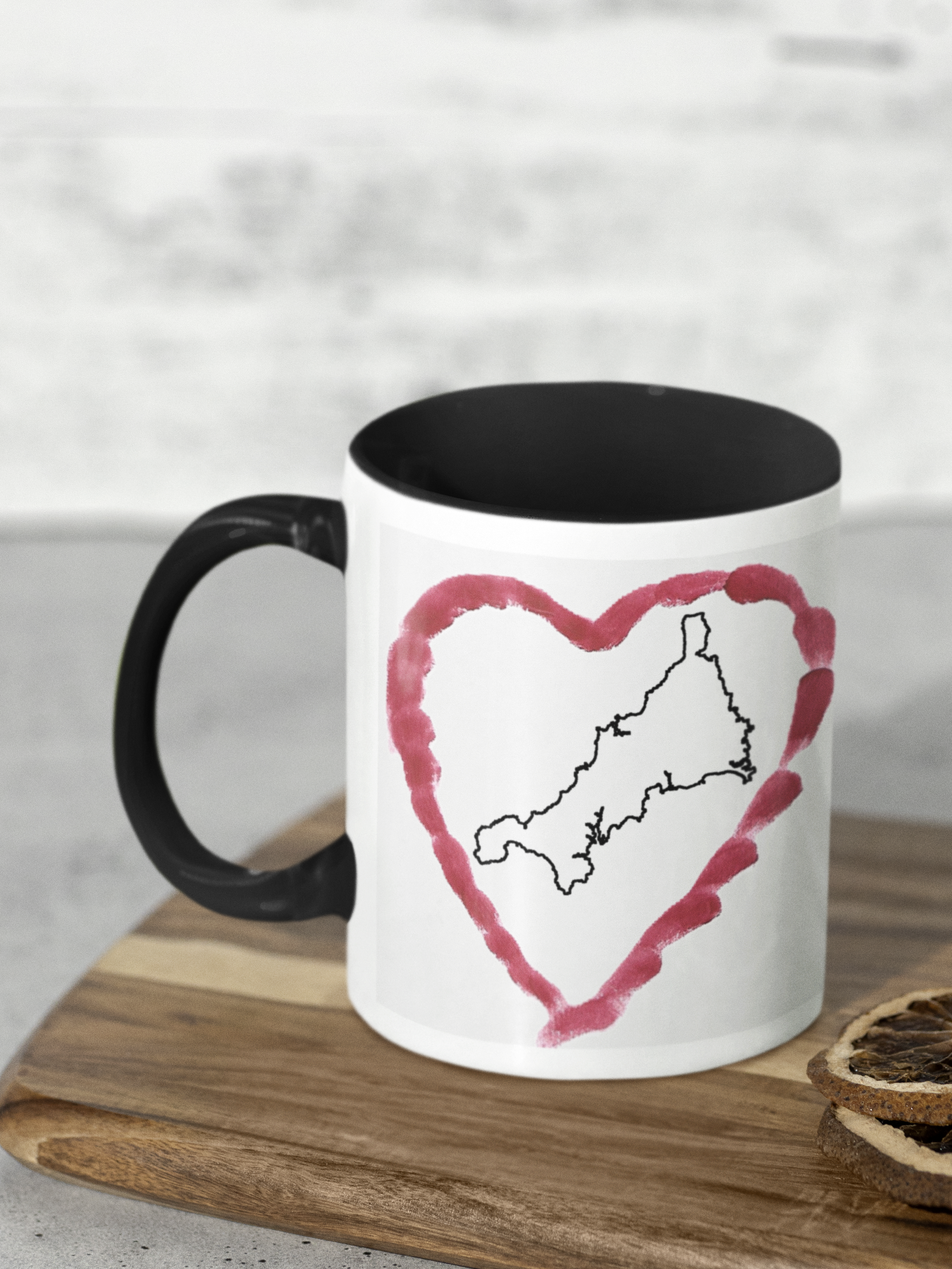 I Love Cornwall heart map mug with black handle on wooden board, Cornwall outline design