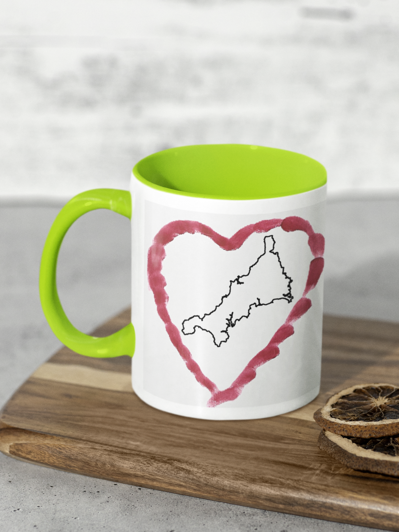I Love Cornwall heart map mug with green handle on wooden board, Cornwall outline design