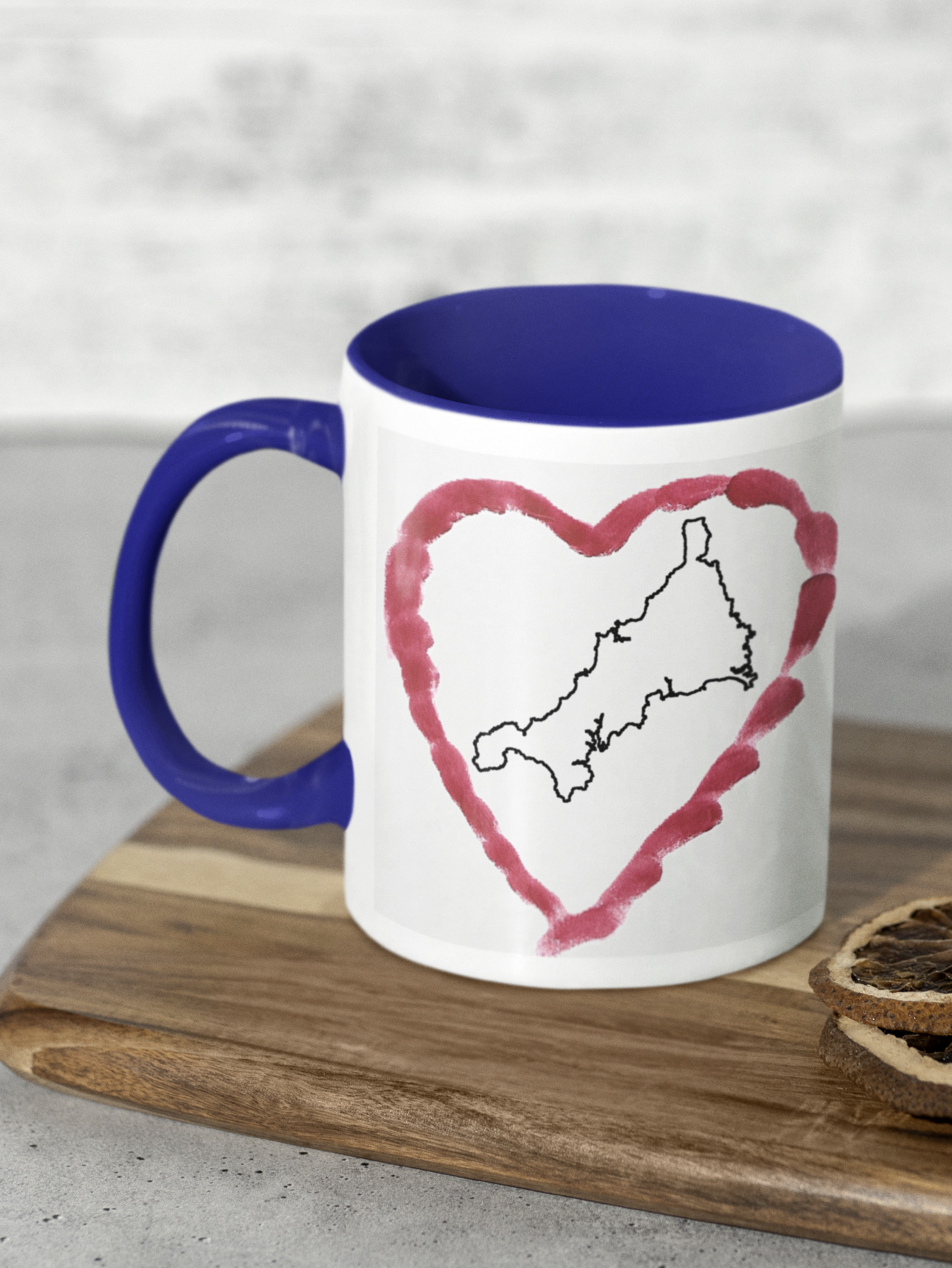 I Love Cornwall heart map mug with navy handle on wooden board, Cornwall outline design
