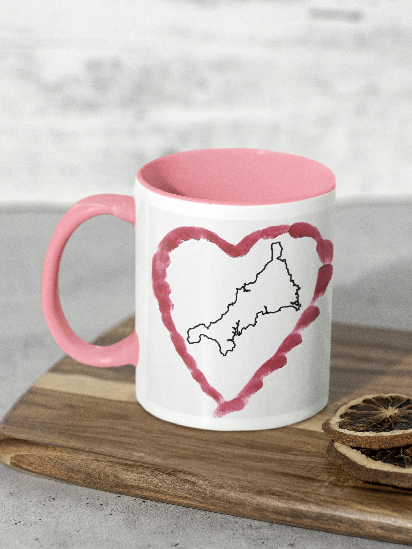 I Love Cornwall heart map mug with pink handle on wooden board, Cornwall outline design