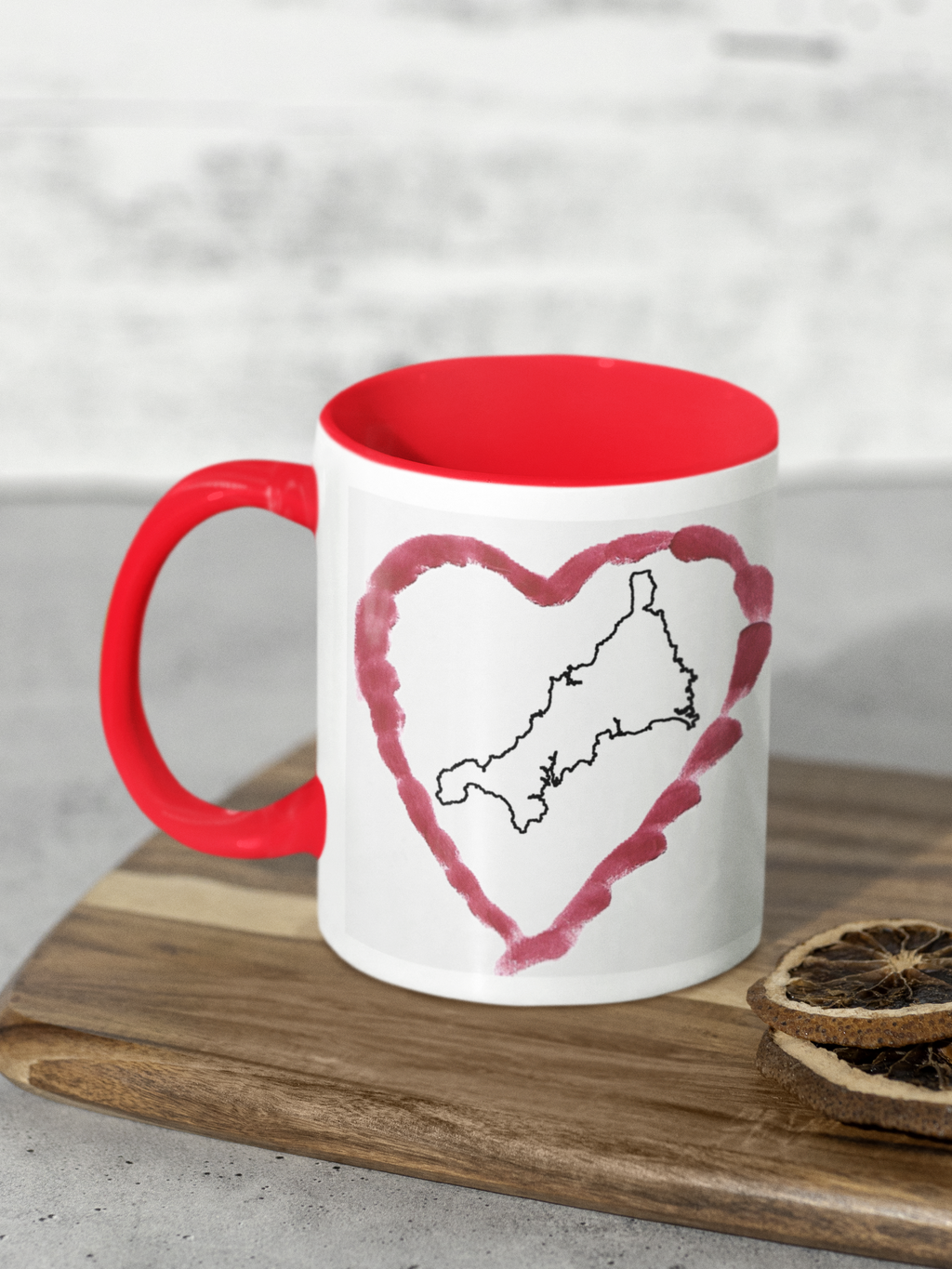 I Love Cornwall heart map mug with red handle on wooden board, Cornwall outline design