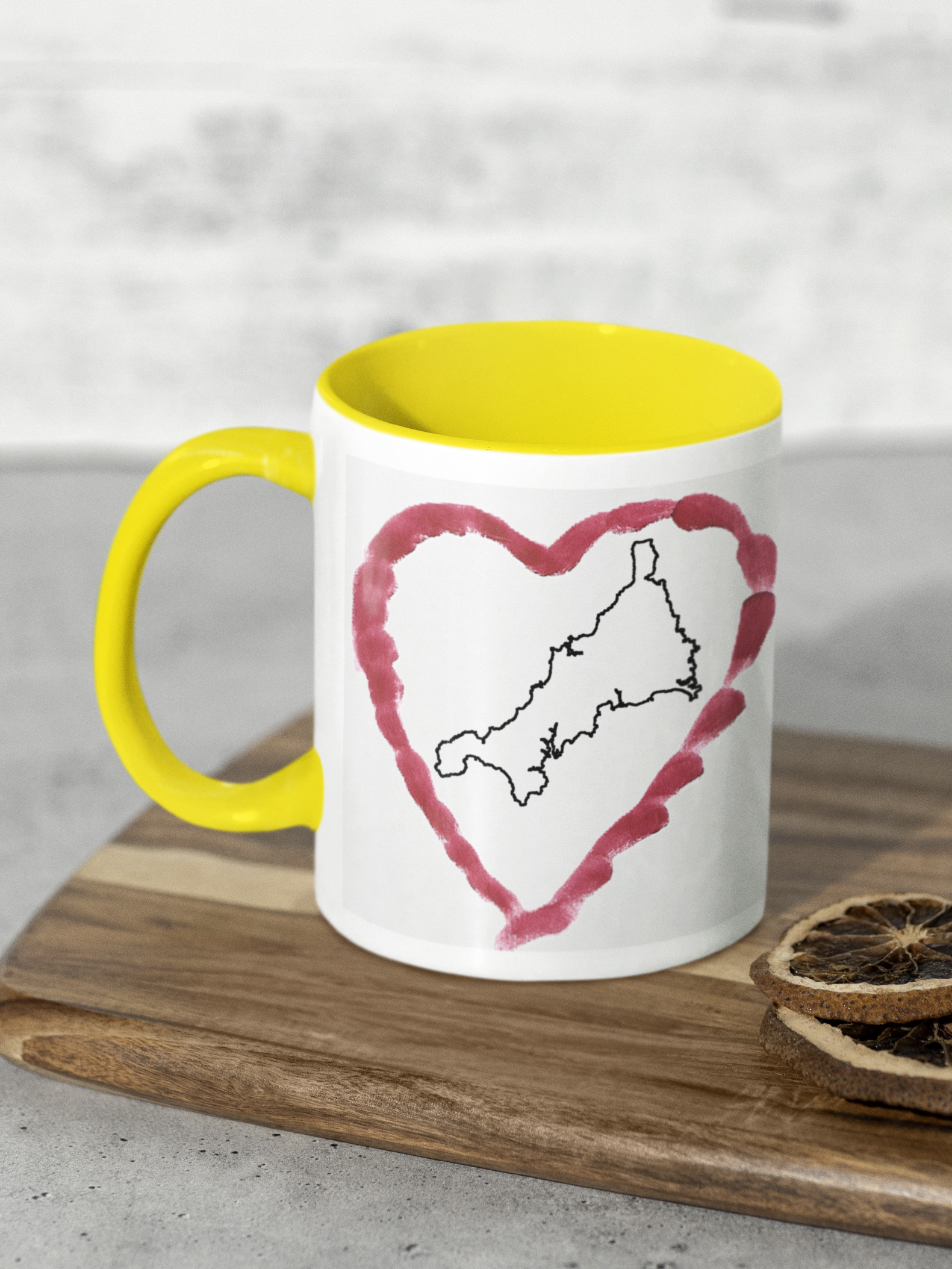 I Love Cornwall heart map mug with yellow handle on wooden board, Cornwall outline design