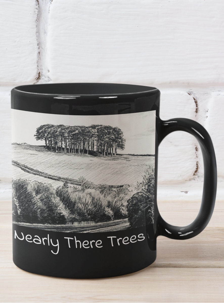 Nearly There Trees all-black mug against white brick wall, Cornwall tree landscape pencil sketch design