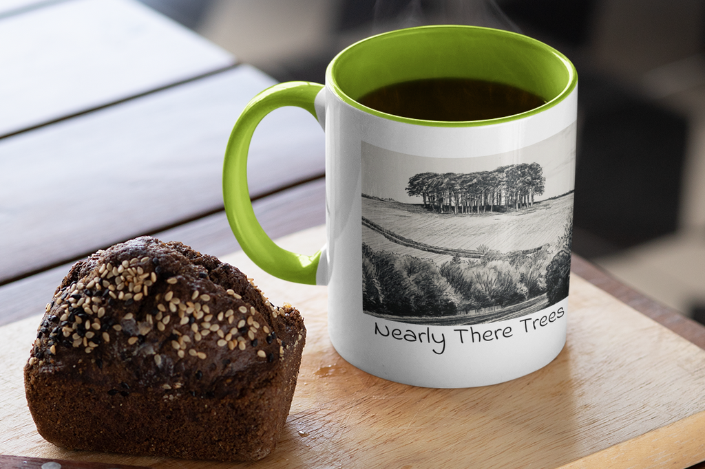 Nearly There Trees green handle mug with steaming coffee beside muffin, Cornwall tree sketch design