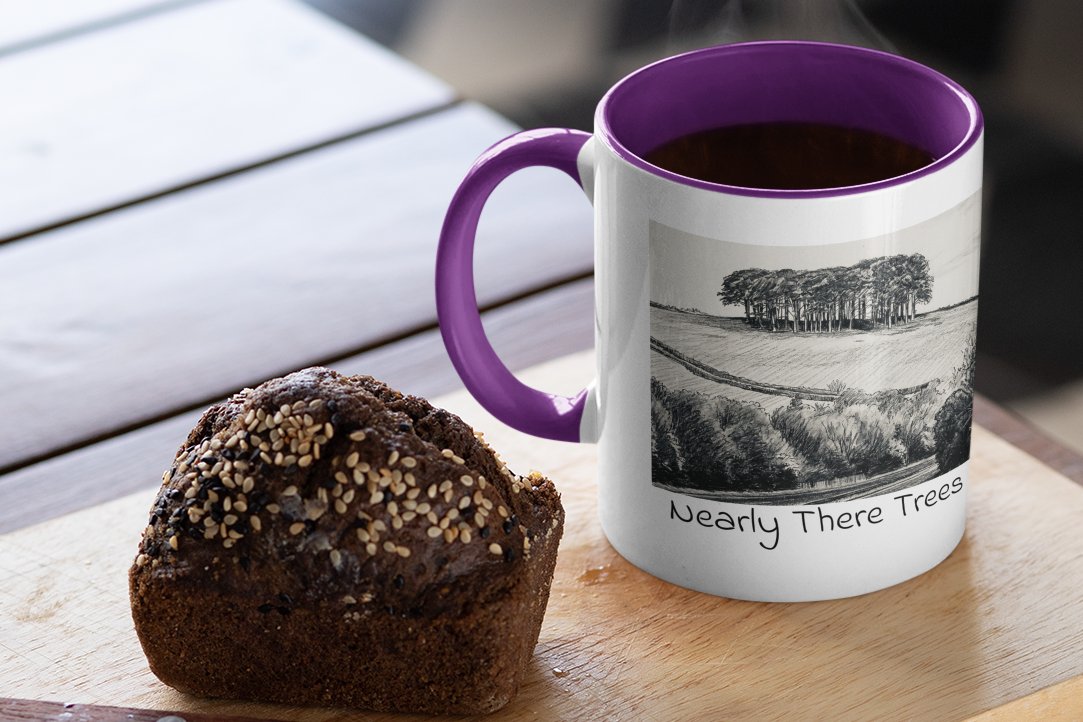 Nearly There Trees mug with purple handle and steaming coffee beside muffin, Cornwall tree sketch design