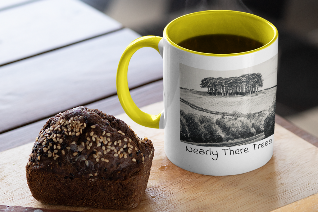 Nearly There Trees mug with yellow handle and steaming coffee beside muffin, Cornwall tree sketch design