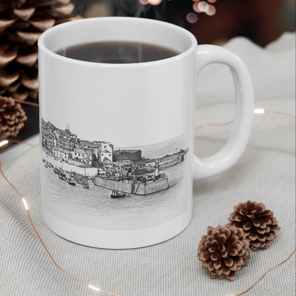 St Ives Harbour Cornwall mug with steaming coffee, styled with pinecones and fairy lights for festive gift photo